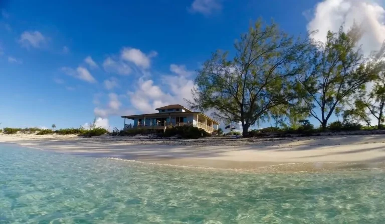 House above the beach seen from the water at Little Majors Spot, Exuma Cays, Exuma