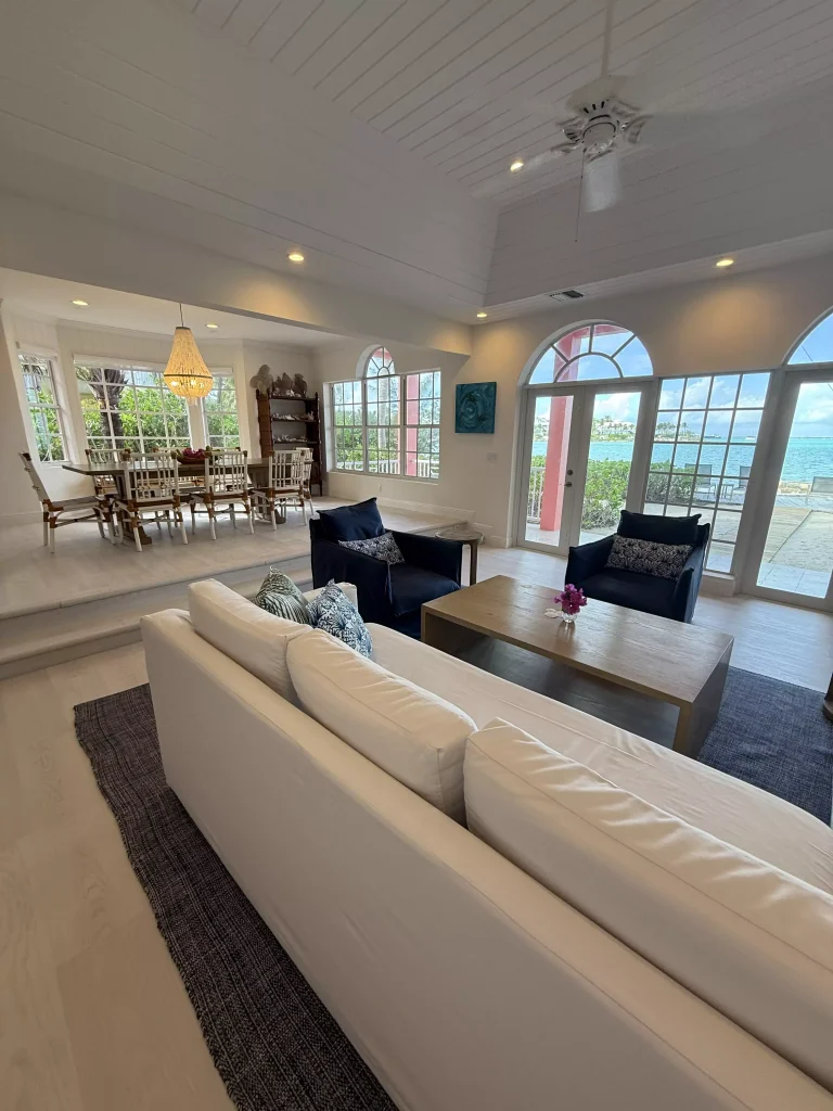Living room with long white sofa at Sea Star Villa, George Town, Great Exuma