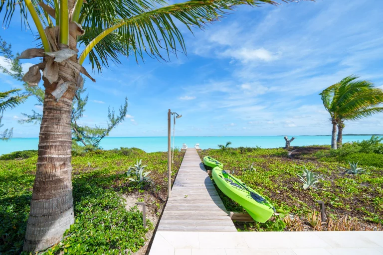 Boardwalk to the beach with a kayak at Seaclusion, George Town, Great Exuma