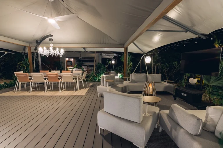 Tented lounge with sofas and dining table at Luxumas, Exuma Cays, Exuma