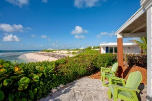 Green Adirondack chairs facing the beach at Ocean View Cottage, Hope Town, Elbow Cay